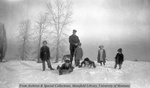 John Flynn sledding with his kids by Mary Helterline Flynn